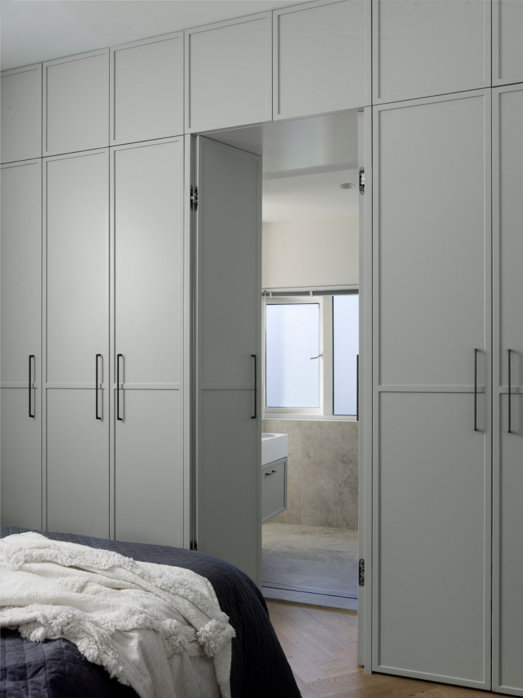 Large contemporary gender-neutral storage and wardrobe in Sydney with shaker cabinets and grey cabinets.