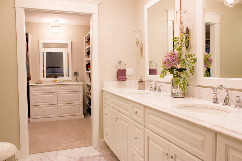 Example of a large transitional master porcelain tile and double-sink bathroom design in Cedar Rapids with a drop-in sink, white cabinets, quartz countertops, beige walls and recessed-panel cabinets