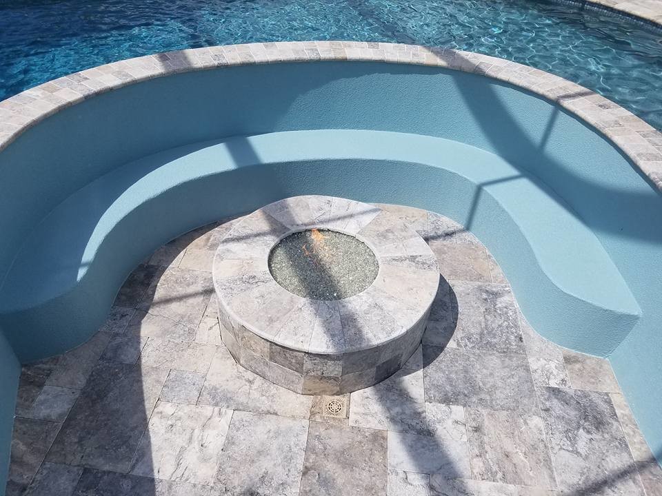 This is an example of a large indoor custom-shaped pool in Tampa with a water feature and decomposed granite.