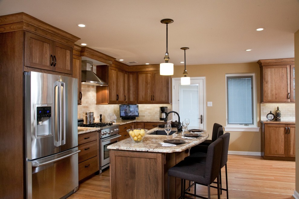 Photo of a transitional galley eat-in kitchen in Philadelphia with a single-bowl sink, shaker cabinets, medium wood cabinets and granite benchtops.