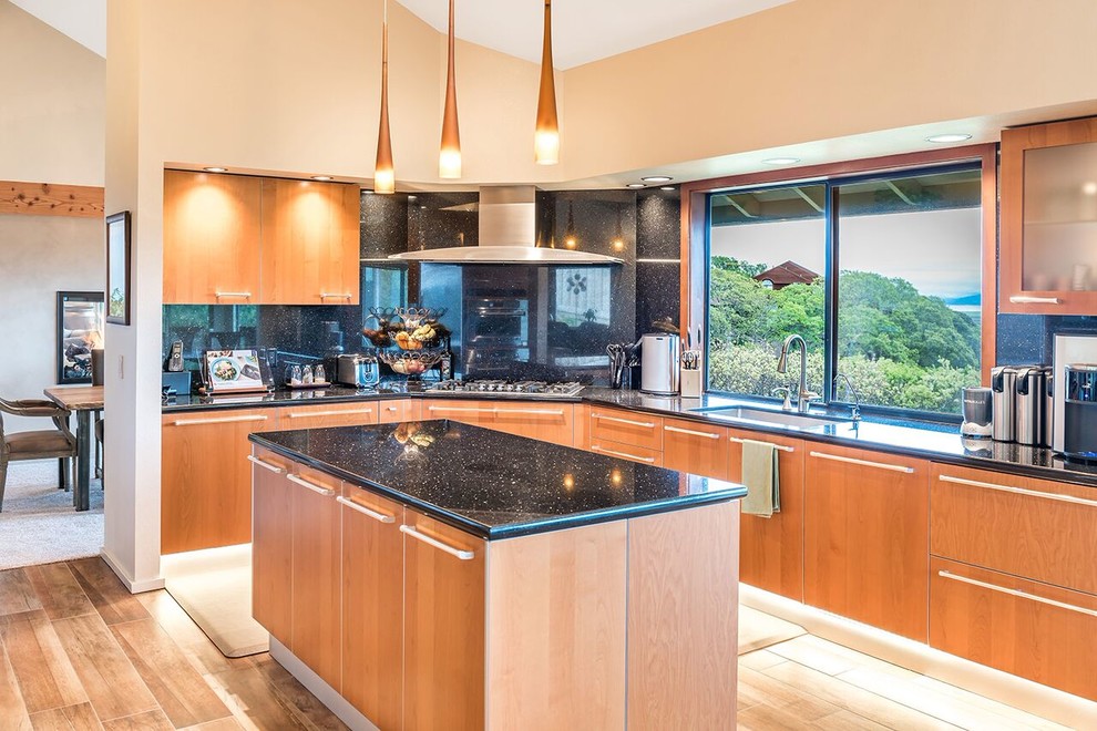 This is an example of a large country u-shaped eat-in kitchen in San Francisco with an undermount sink, flat-panel cabinets, light wood cabinets, quartz benchtops, black splashback, stone slab splashback, stainless steel appliances, medium hardwood floors, with island and brown floor.