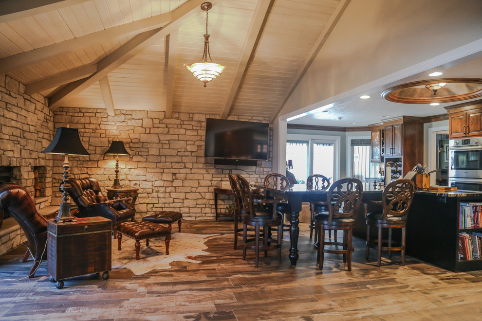 Inspiration for a mid-sized transitional porcelain tile home design remodel with white walls, a standard fireplace and a stone fireplace
