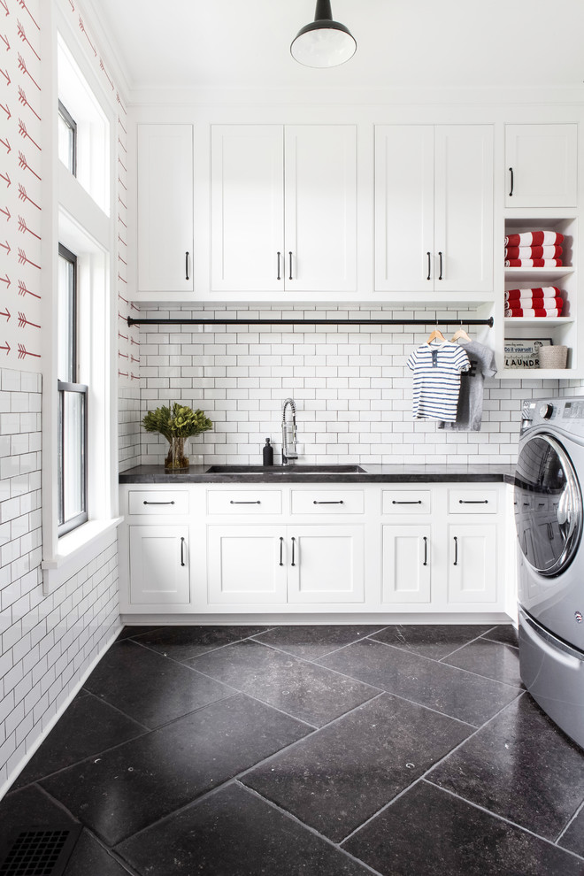 Design ideas for a large country u-shaped utility room in New York with an undermount sink, recessed-panel cabinets, white cabinets, concrete benchtops, red walls, limestone floors, a side-by-side washer and dryer, black floor and grey benchtop.
