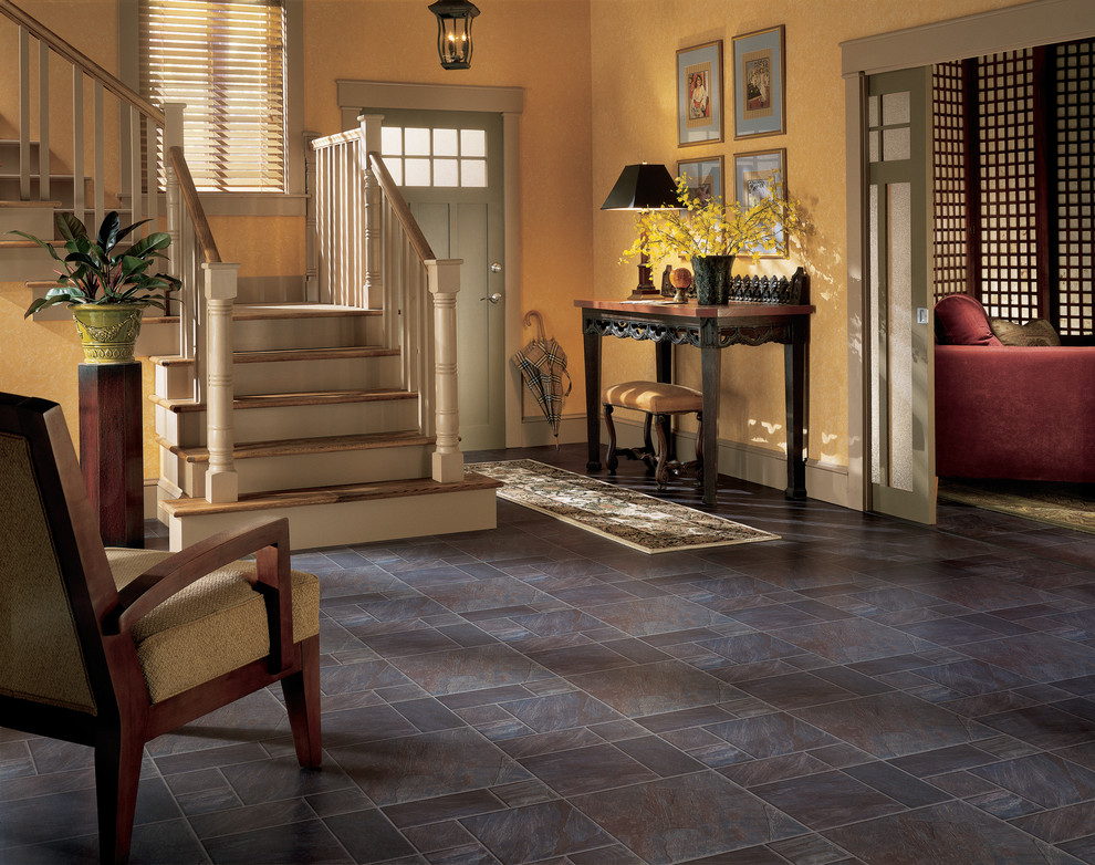 Photo of a mid-sized transitional foyer in Boston with yellow walls, slate floors, a single front door and a green front door.