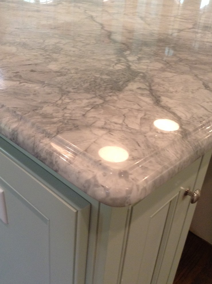 Large transitional kitchen photo in Atlanta with a single-bowl sink, white cabinets, quartz countertops, gray backsplash, stone tile backsplash and an island