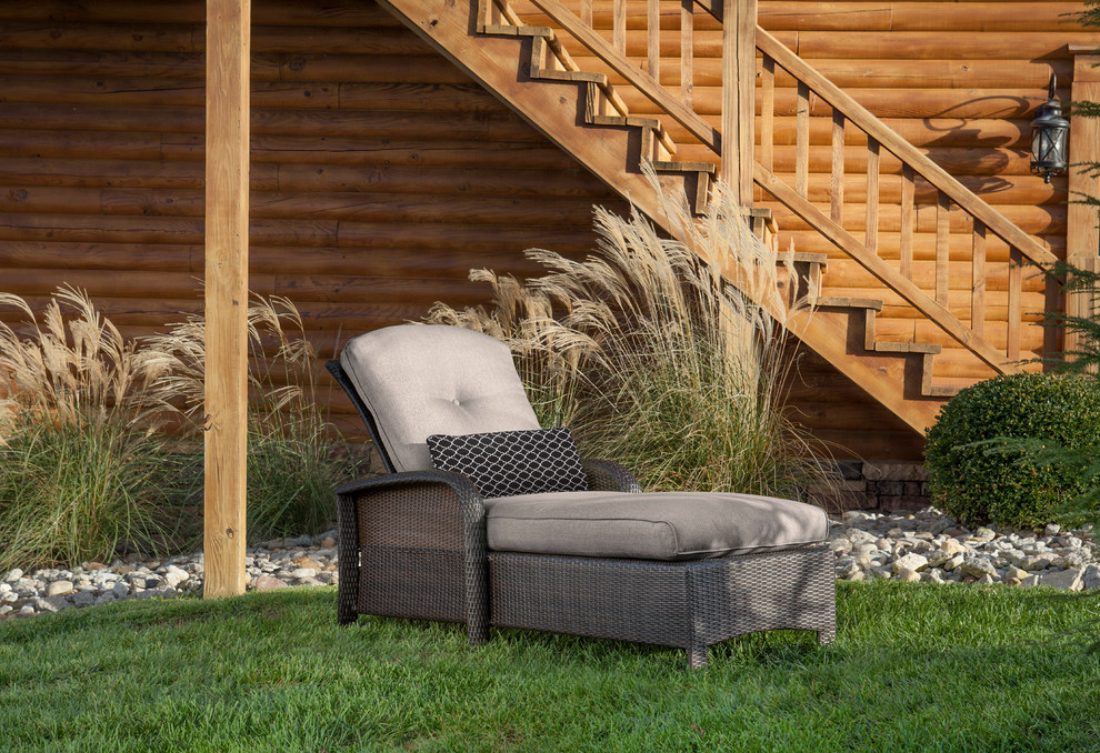Example of a transitional backyard home design design