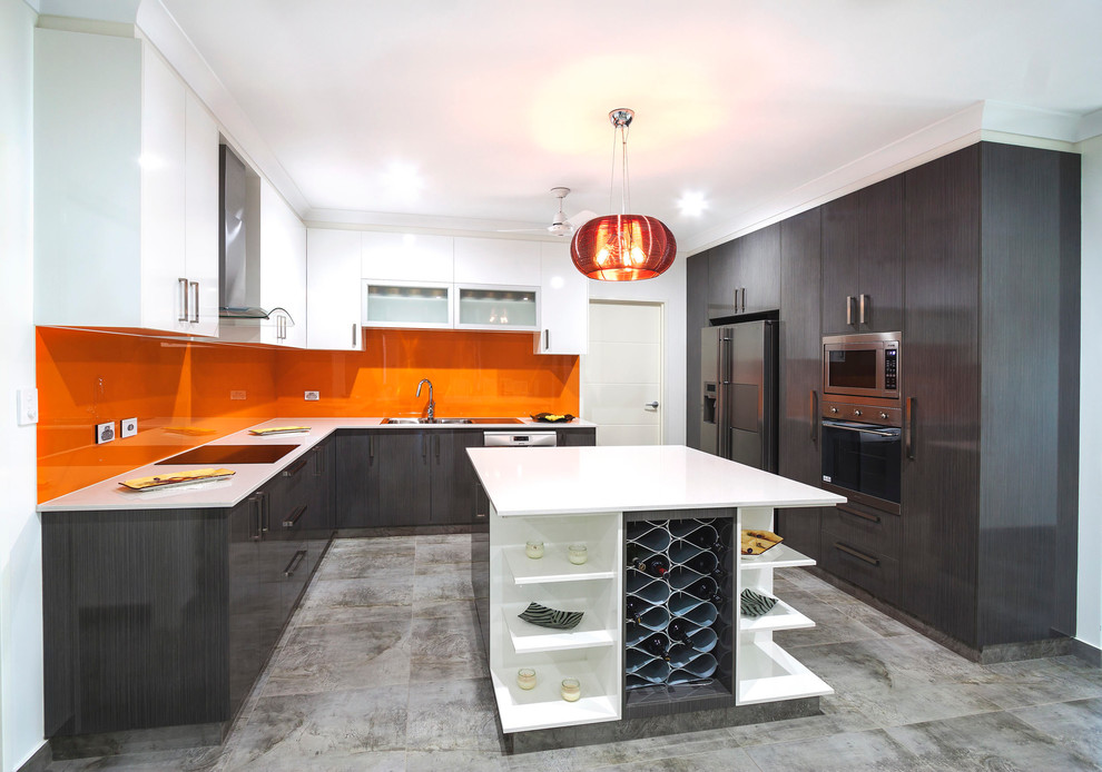 Design ideas for a large contemporary u-shaped eat-in kitchen in Darwin with a double-bowl sink, grey cabinets, solid surface benchtops, orange splashback, glass sheet splashback, stainless steel appliances, porcelain floors and with island.