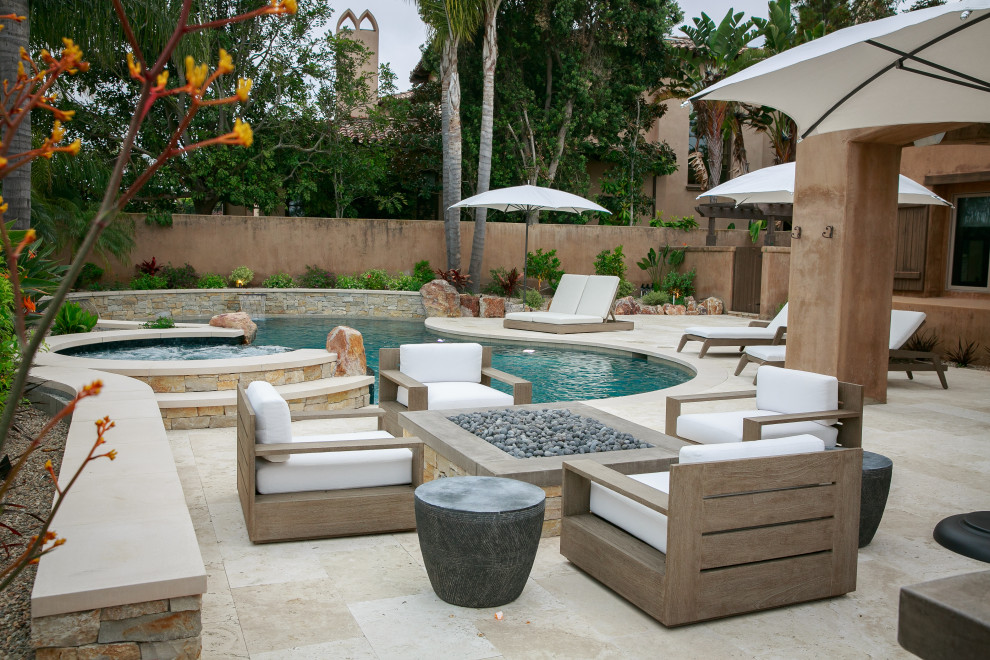 Medium sized classic back custom shaped swimming pool in San Diego with natural stone paving.