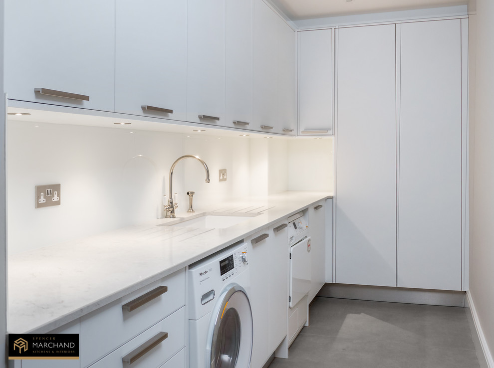 Design ideas for a contemporary laundry room in Buckinghamshire with white cabinets, quartzite benchtops, stone slab splashback and porcelain floors.