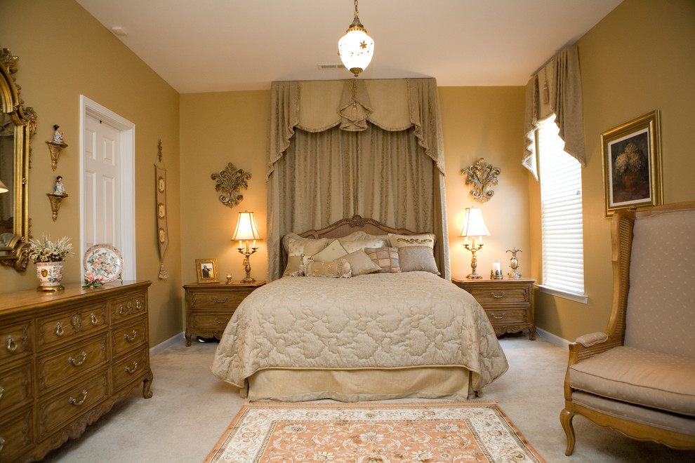 Inspiration for a large mediterranean master carpeted bedroom remodel in Other with beige walls and no fireplace