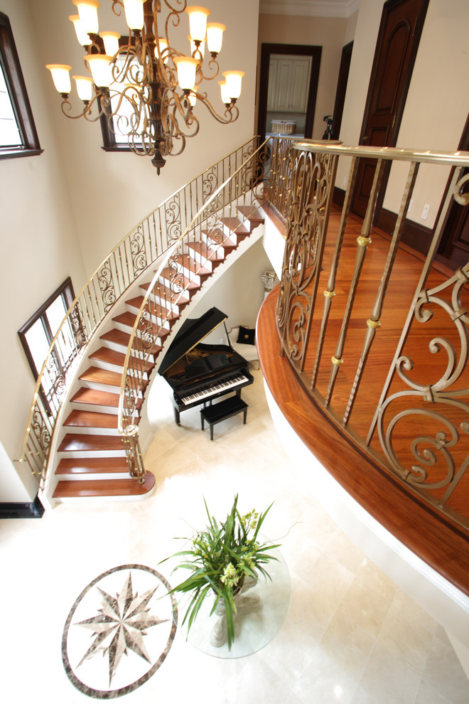 Inspiration for a large traditional wood curved staircase in San Francisco with painted wood risers and metal railing.
