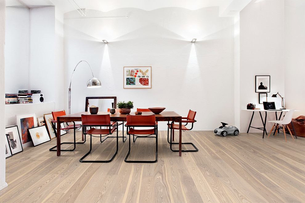 This is an example of a large scandinavian separate dining room in Chicago with white walls and medium hardwood floors.