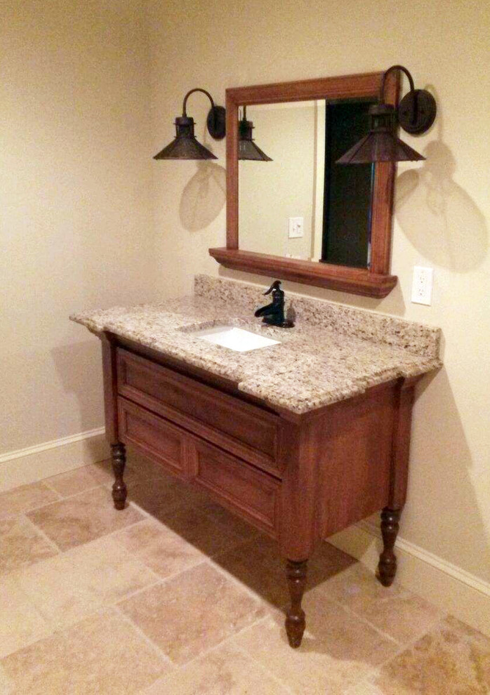 This is an example of a small traditional 3/4 bathroom in New York with an undermount sink, recessed-panel cabinets, medium wood cabinets, granite benchtops and beige tile.