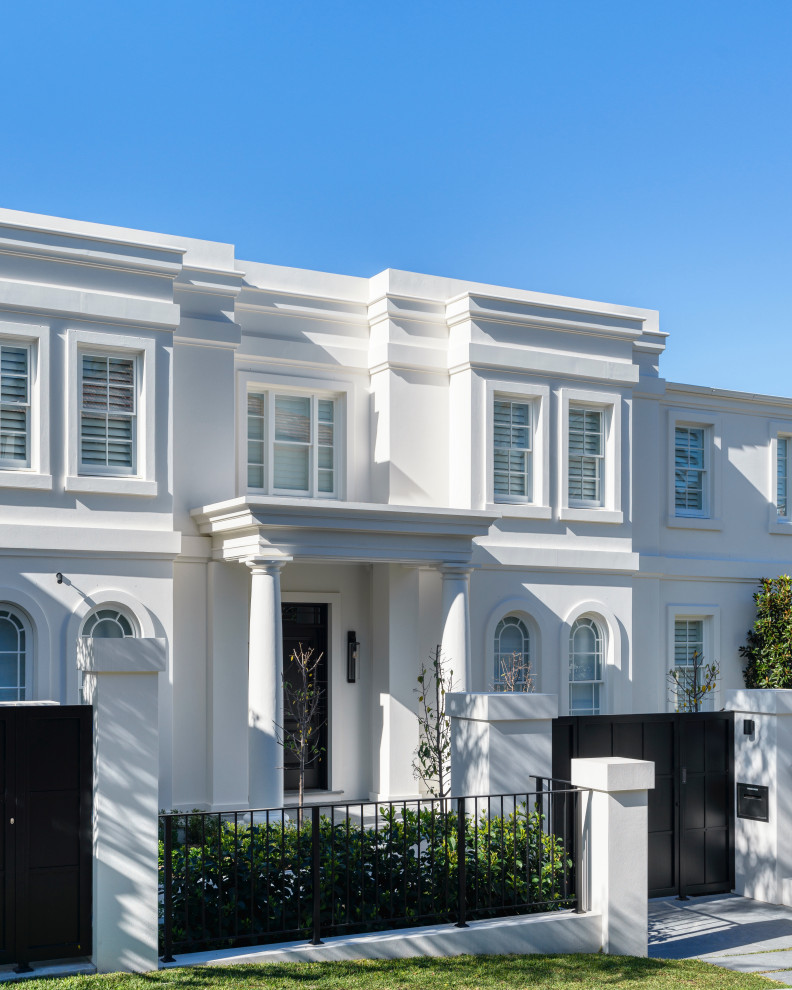 Inspiration for an expansive transitional stucco house exterior in Sydney.
