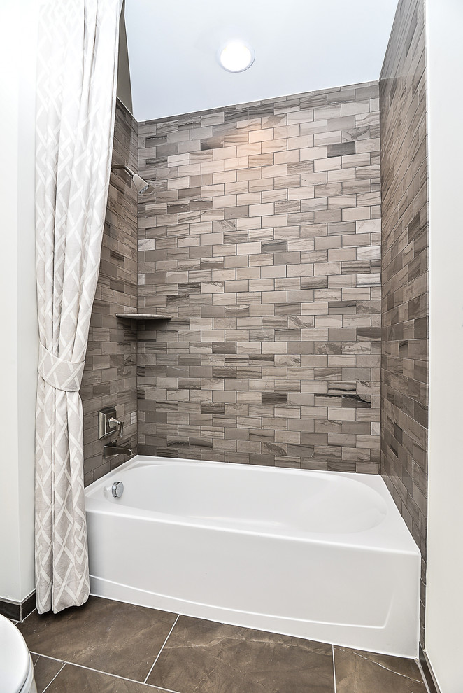 Design ideas for a mid-sized transitional 3/4 bathroom in DC Metro with shaker cabinets, grey cabinets, a freestanding tub, an alcove shower, a two-piece toilet, gray tile, porcelain tile, multi-coloured walls, vinyl floors, an undermount sink and quartzite benchtops.