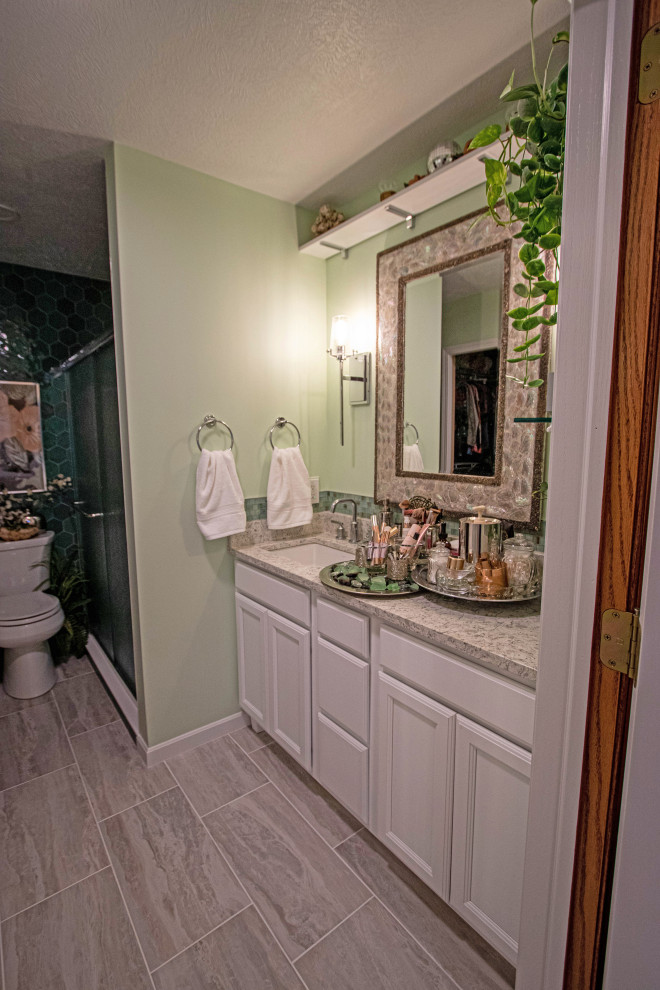 Design ideas for a mid-sized transitional master bathroom in Cleveland with flat-panel cabinets, white cabinets, a corner shower, green tile, ceramic tile, ceramic floors, an undermount sink, engineered quartz benchtops, beige floor, a sliding shower screen, beige benchtops and a single vanity.