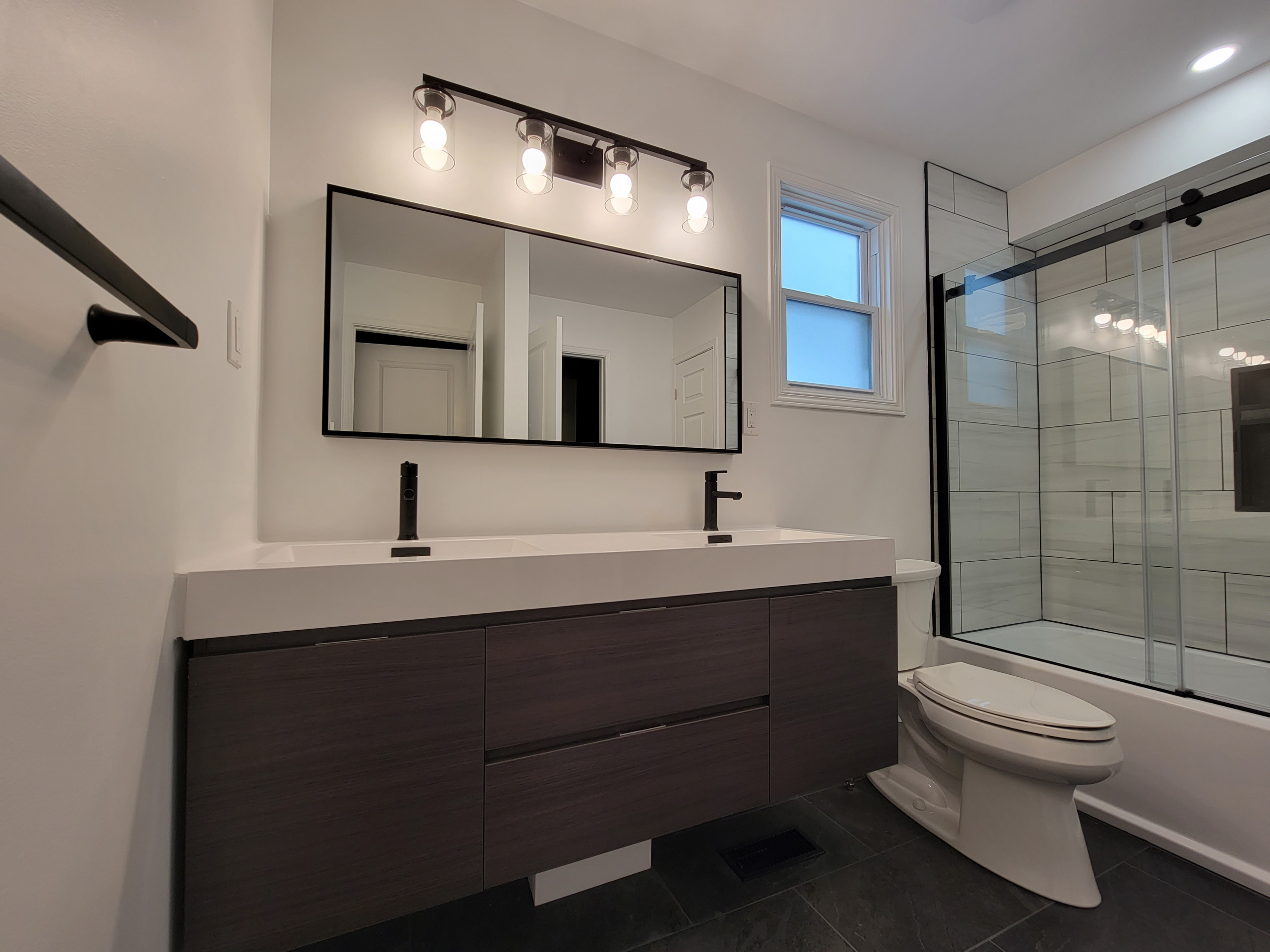 Full Bathroom with Black and White Features