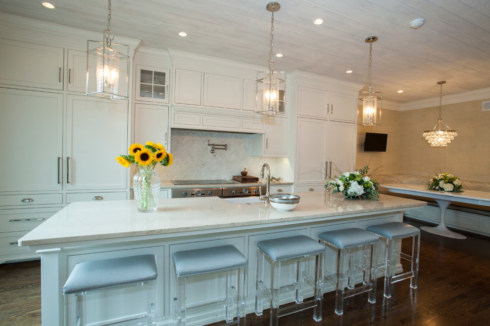 Design ideas for a large traditional galley eat-in kitchen in Philadelphia with a farmhouse sink, beaded inset cabinets, white cabinets, limestone benchtops, white splashback, matchstick tile splashback, white appliances, dark hardwood floors and with island.