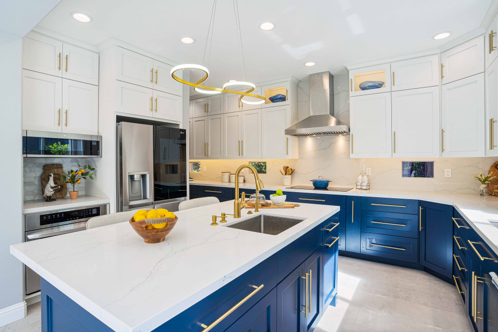 Medium sized eclectic u-shaped kitchen/diner in San Francisco with a submerged sink, shaker cabinets, blue cabinets, engineered stone countertops, white splashback, marble splashback, stainless steel appliances, porcelain flooring, an island, grey floors and white worktops.