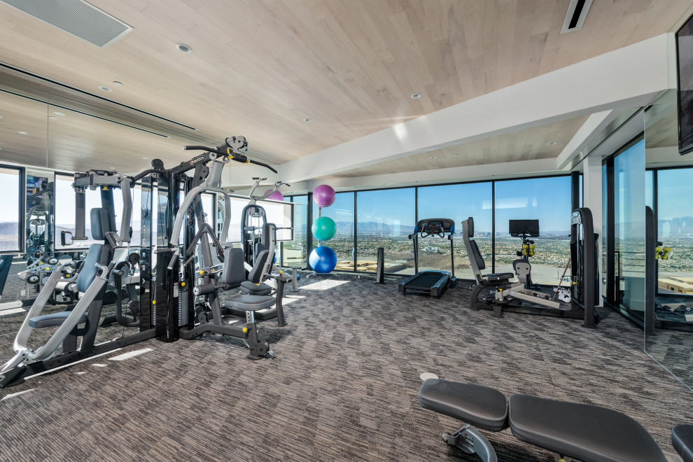 Expansive contemporary home weight room in Las Vegas with carpet.