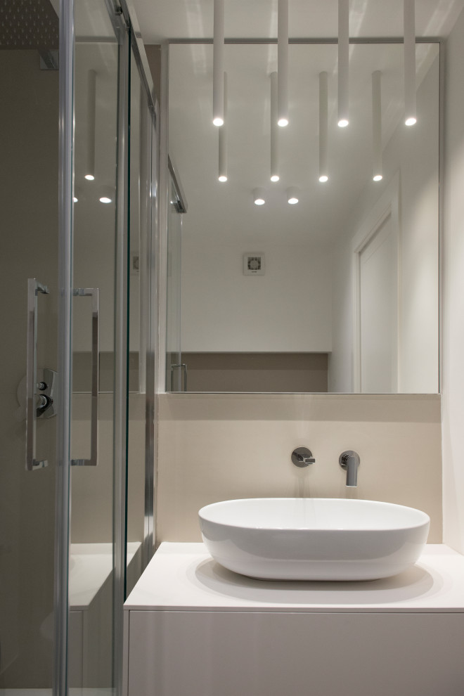 Small bathroom in Rome with flat-panel cabinets, white cabinets, a two-piece toilet, white tile, porcelain tile, white walls, porcelain floors, a vessel sink, laminate benchtops, blue floor and white benchtops.