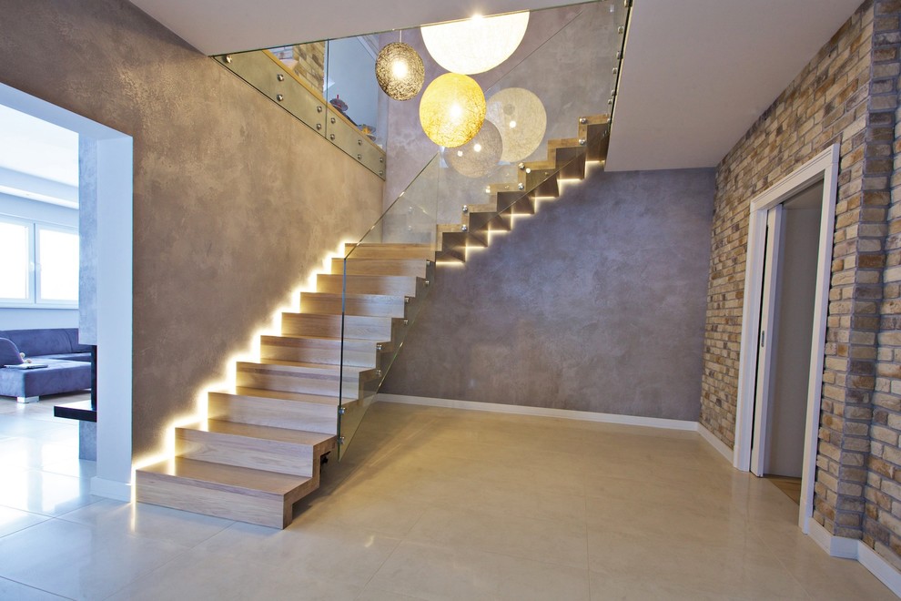 This is an example of an expansive contemporary wood floating staircase in Other with wood risers.
