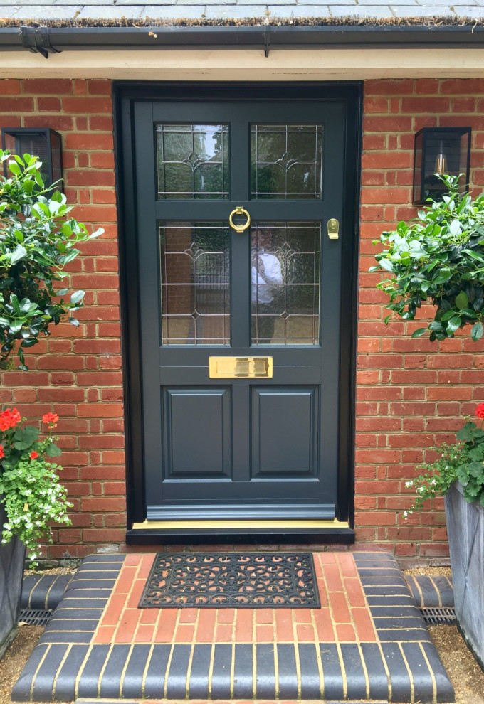 This is an example of a mid-sized traditional front door in Essex with a single front door and a green front door.