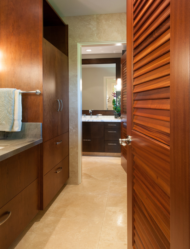 Design ideas for a mid-sized contemporary master bathroom in Hawaii with flat-panel cabinets, dark wood cabinets, a freestanding tub, blue tile, brown tile, glass tile, beige walls and soapstone benchtops.