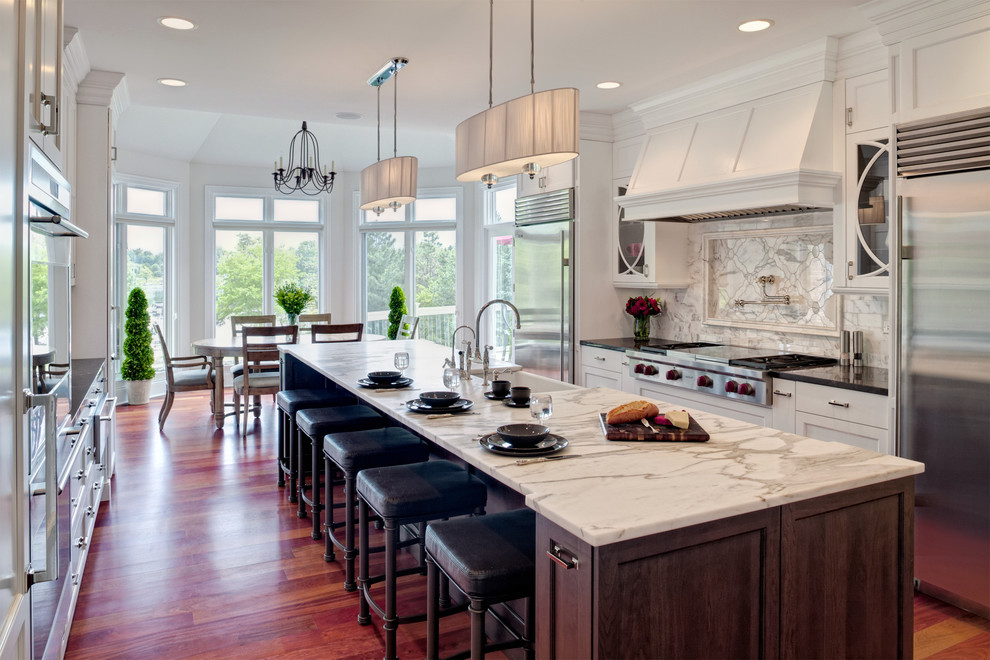 Transitional eat-in kitchen in Chicago with white cabinets, marble benchtops, stainless steel appliances, a farmhouse sink and recessed-panel cabinets.