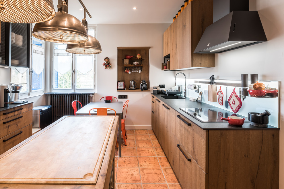 Design ideas for a mid-sized contemporary galley separate kitchen in Lyon with an undermount sink, tile benchtops, white splashback, glass sheet splashback, stainless steel appliances, terra-cotta floors, no island and orange floor.