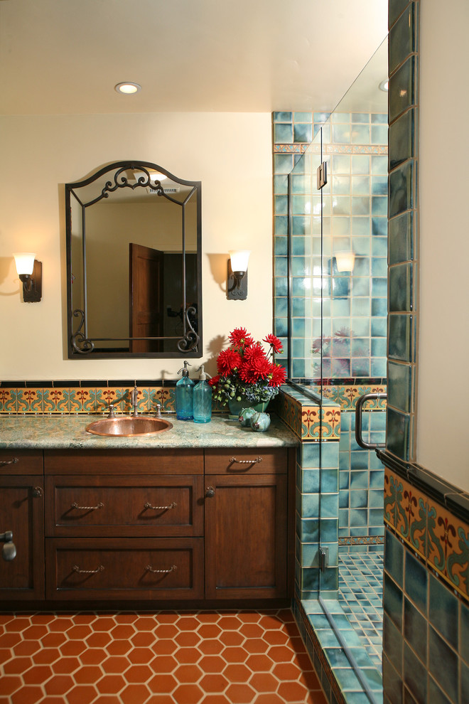 Design ideas for a large mediterranean bathroom in Los Angeles with a drop-in sink, dark wood cabinets, an alcove shower, blue tile, shaker cabinets, granite benchtops, white walls, terra-cotta floors and orange floor.