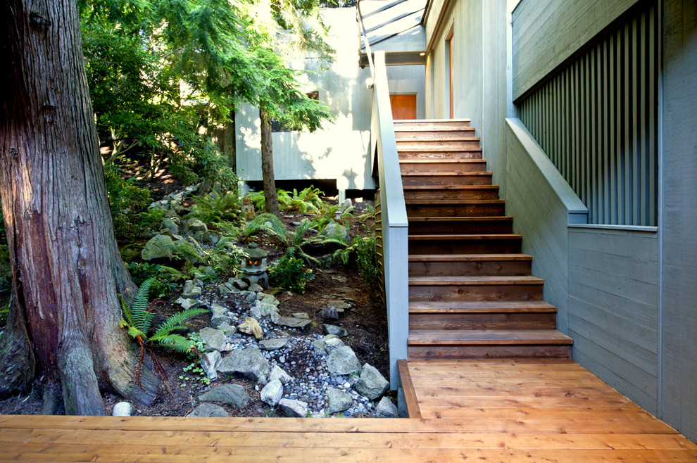 Design ideas for a large modern two-storey green exterior in Vancouver with wood siding and a flat roof.