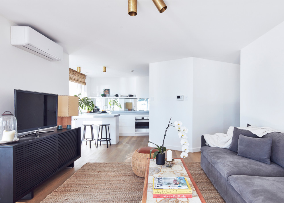 Design ideas for a small scandinavian u-shaped open plan kitchen in Sydney with white cabinets, mirror splashback, stainless steel appliances, no island and grey benchtop.