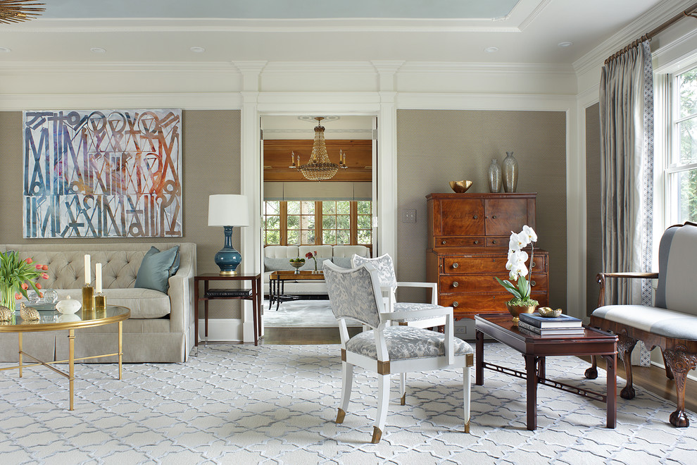 Living Room - A truly elegant living room combining antiques and contemporary pieces. Artwork above the sofa adds a focal point to the room. The old bones of this home were preserved while updating the decor for a modern transitional aesthetic. Photography by Peter Rymwid.