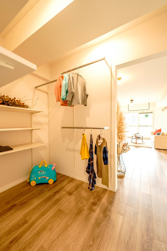 Scandinavian storage and wardrobe in Other with plywood floors, grey floor and wallpaper.