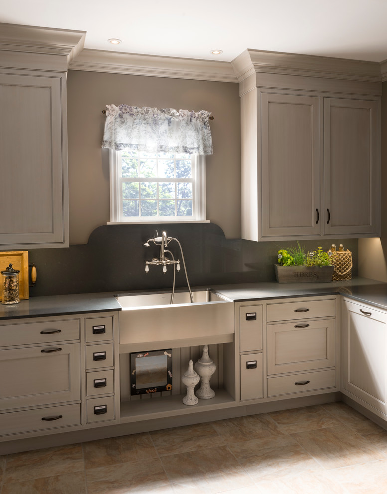 Large transitional l-shaped utility room in Other with a farmhouse sink, recessed-panel cabinets, white cabinets, brown walls and a concealed washer and dryer.