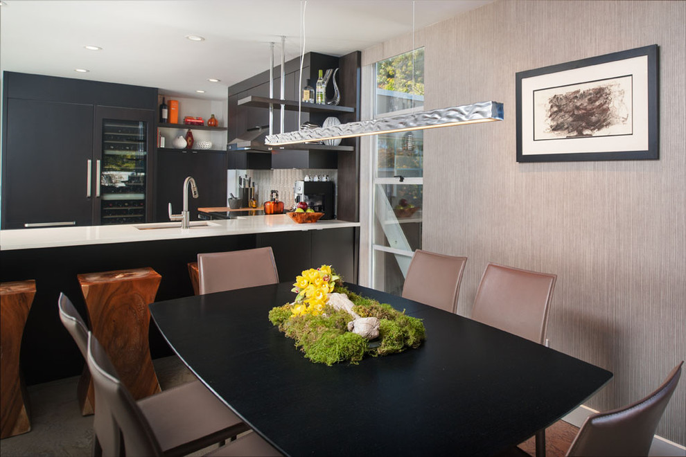 Mid-sized modern u-shaped open plan kitchen in Vancouver with an undermount sink, flat-panel cabinets, black cabinets, stainless steel appliances, quartz benchtops, white splashback and glass tile splashback.