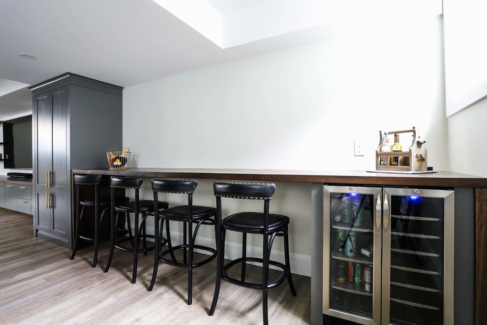 Inspiration for a large transitional look-out vinyl floor and brown floor basement remodel with white walls