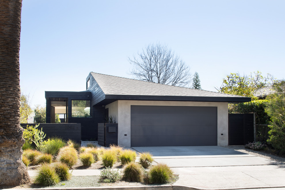 Design ideas for a mid-sized modern one-storey concrete black house exterior in San Francisco with a clipped gable roof, a shingle roof and a black roof.