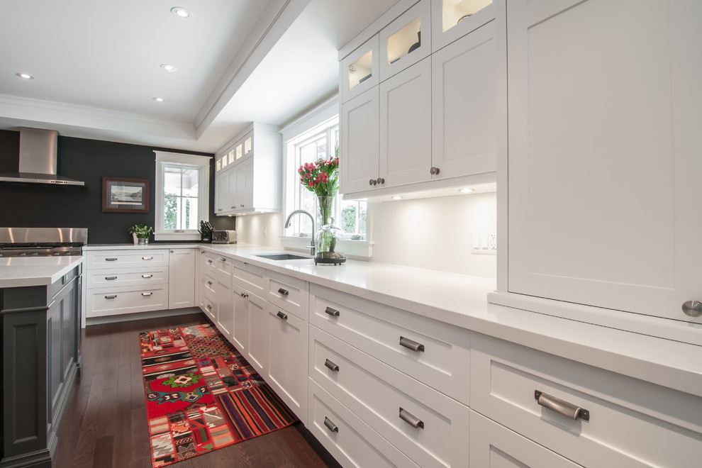 Design ideas for a modern l-shaped separate kitchen in Toronto with an undermount sink, shaker cabinets, white cabinets, marble benchtops, white splashback, stainless steel appliances, dark hardwood floors and with island.