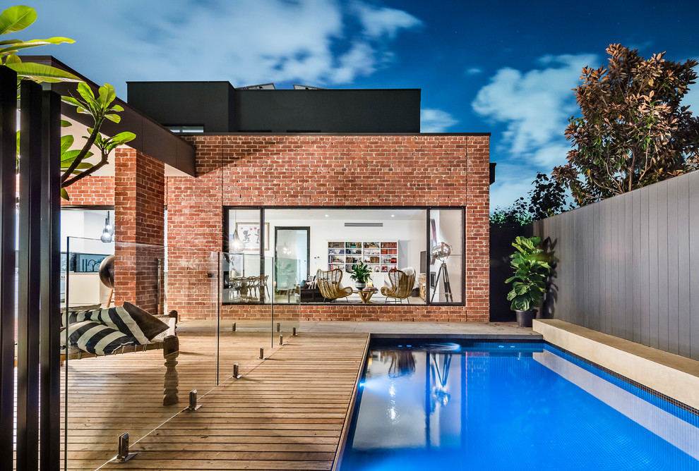 Inspiration for a large contemporary backyard rectangular lap pool in Adelaide with decking.