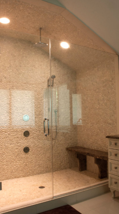 Inspiration for a large transitional master gray tile and pebble tile porcelain tile and beige floor alcove shower remodel in Chicago with beige walls and a hinged shower door