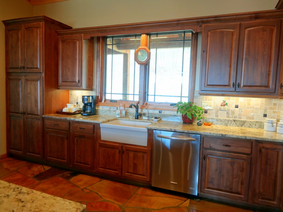 Inspiration for a mid-sized rustic l-shaped slate floor open concept kitchen remodel in Charlotte with a farmhouse sink, raised-panel cabinets, dark wood cabinets, granite countertops, multicolored backsplash, ceramic backsplash, stainless steel appliances and a peninsula