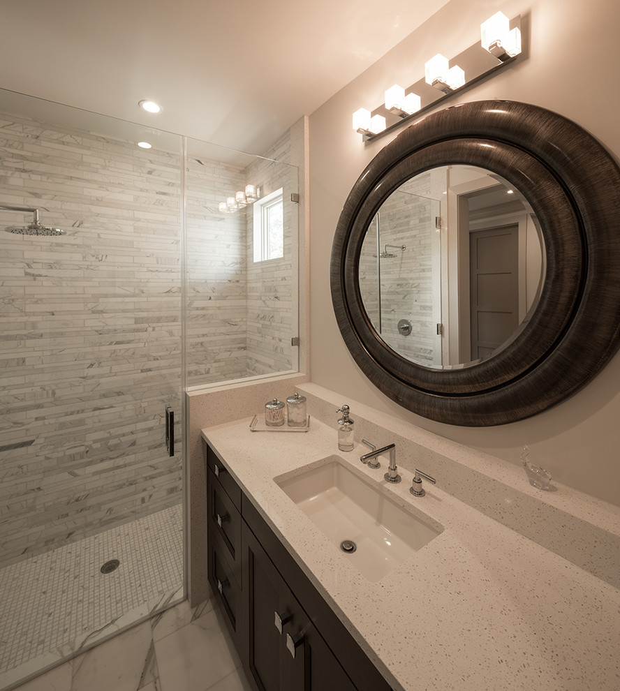 Photo of a mid-sized transitional bathroom in Houston with recessed-panel cabinets, dark wood cabinets, an alcove shower, beige walls, an undermount sink, terrazzo benchtops and a hinged shower door.