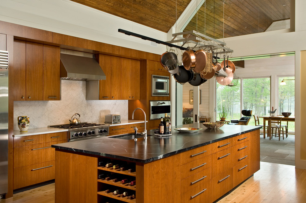 This is an example of a modern kitchen in Boston with stainless steel appliances and soapstone benchtops.