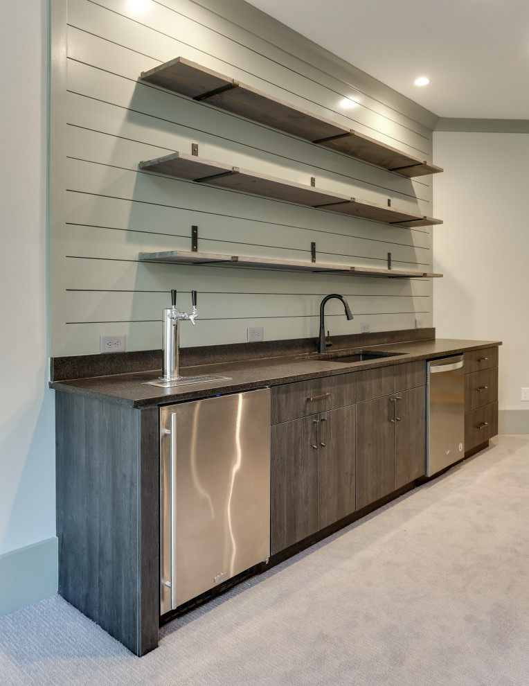 Mid-sized transitional galley wet bar in Raleigh with an undermount sink, flat-panel cabinets, grey cabinets, granite benchtops, carpet, grey floor and brown benchtop.