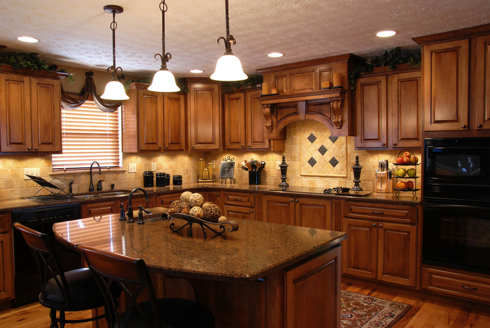 Example of a mid-sized l-shaped medium tone wood floor enclosed kitchen design with a double-bowl sink, raised-panel cabinets, dark wood cabinets, granite countertops, beige backsplash, stone tile backsplash, stainless steel appliances and an island