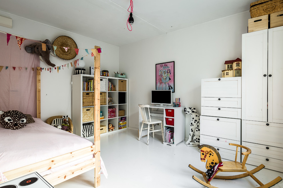 Inspiration for a scandinavian kids' room in Stockholm with white walls and white floor.