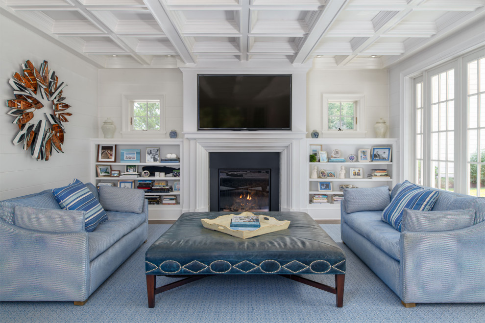This is an example of a transitional living room in Boston with white walls, medium hardwood floors, a standard fireplace, a wall-mounted tv and brown floor.