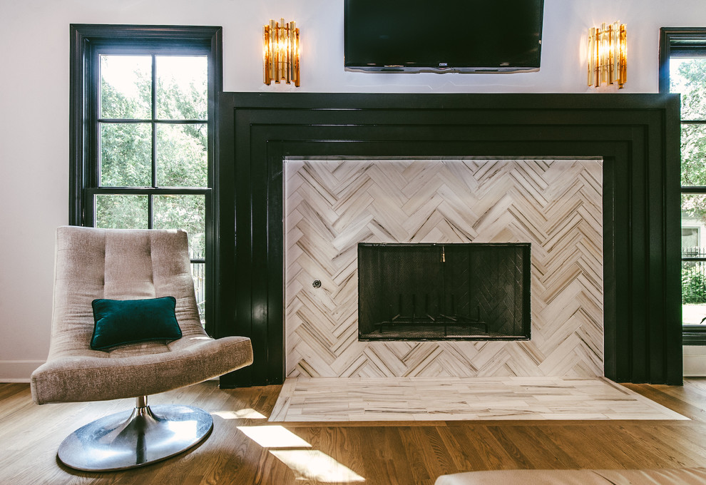 Photo of a large contemporary enclosed living room in Austin with medium hardwood floors, a standard fireplace and a stone fireplace surround.